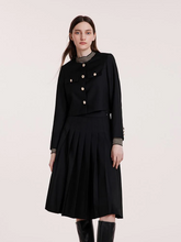 a lady in black jacket with black a-lined midi skirt